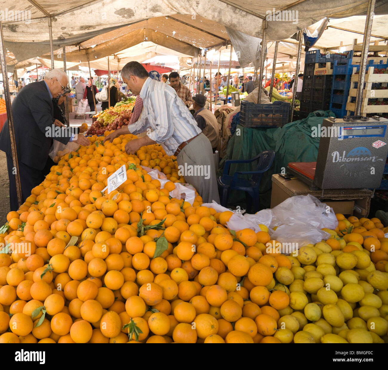 Turkey Antalya - Manavgat market fruit - citrus grower with heavy duty digital scales for bulk sales of crop Stock Photo