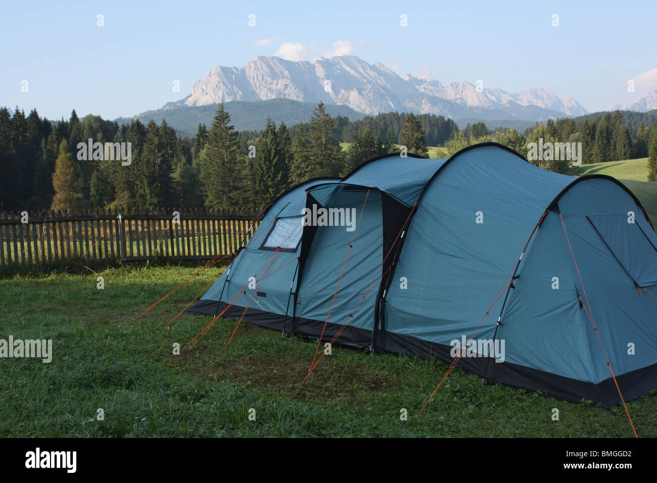 Blue tent on a campsite surrounded by meadows and trees in the German Alps in Bavaria, Germany Stock Photo