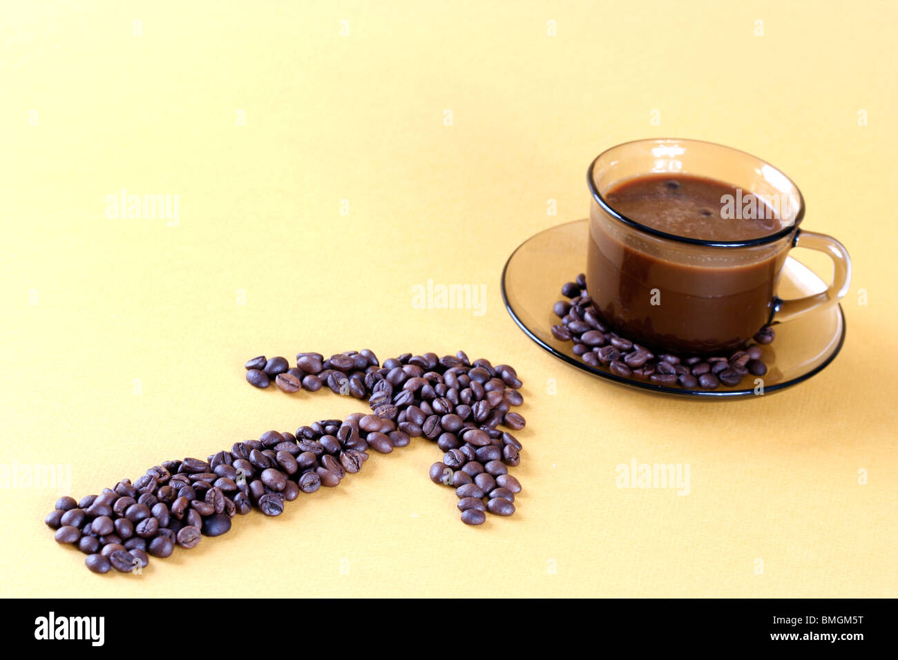 Cup with coffee, costing on coffee grain. Stock Photo