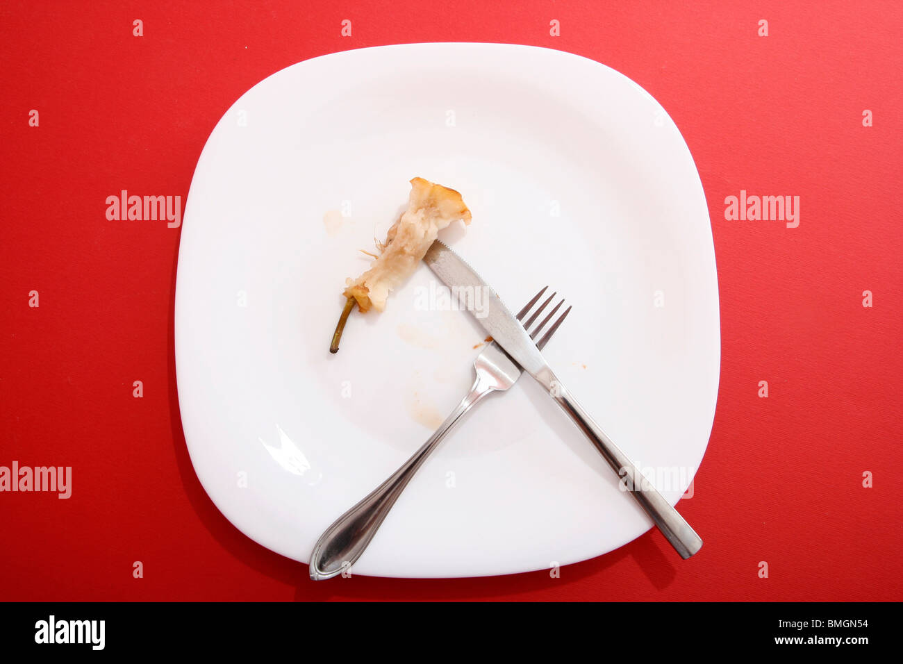 Pear core on a white plate. Stock Photo
