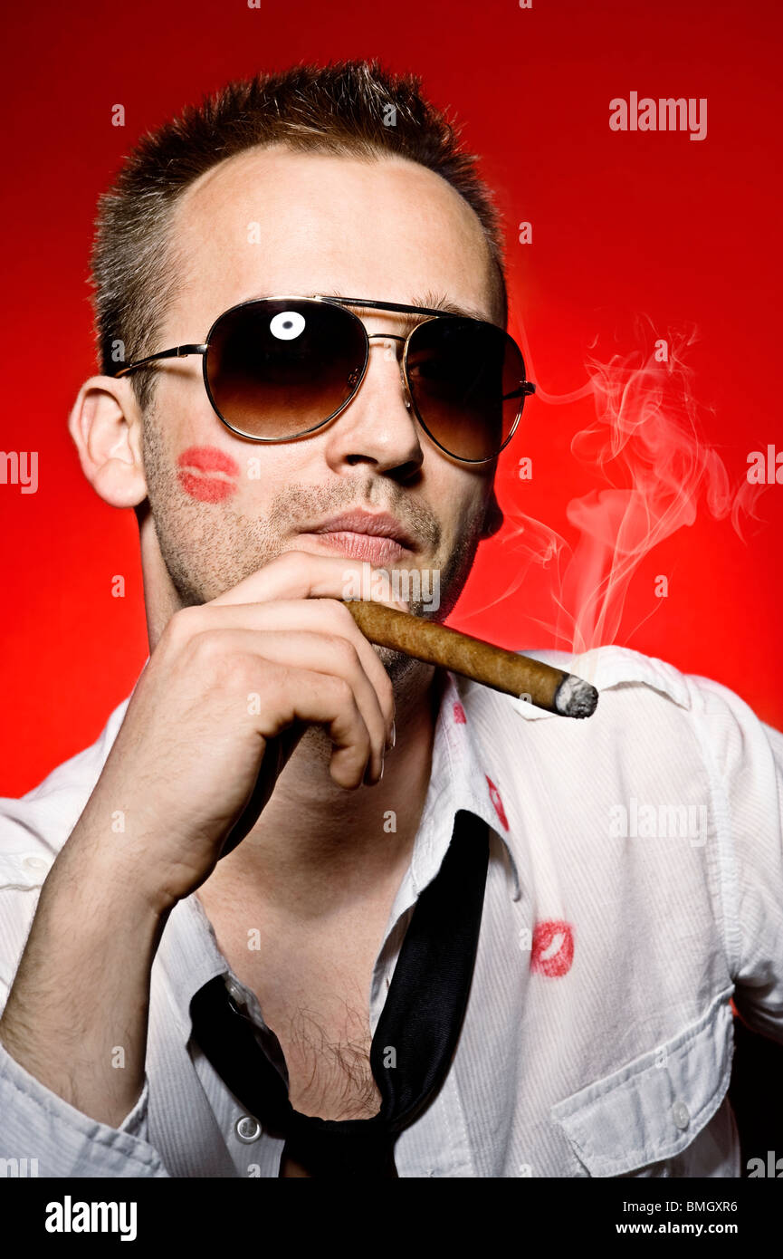 young handsome man with lips imprint smoking cigar Stock Photo