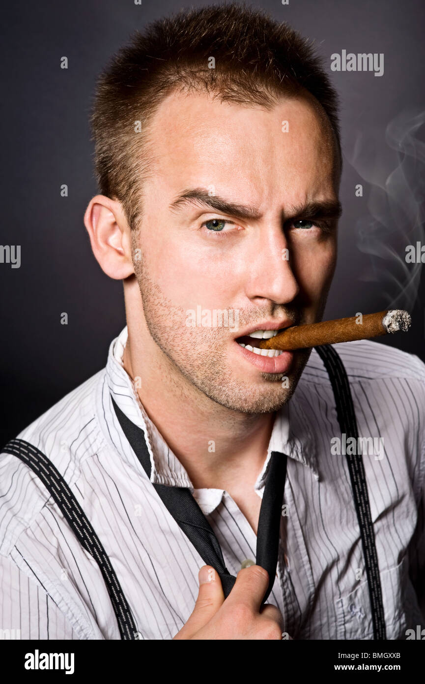 young handsome man smoking cigar Stock Photo Alamy