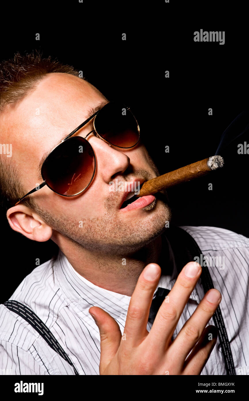 young handsome man smoking cigar Stock Photo