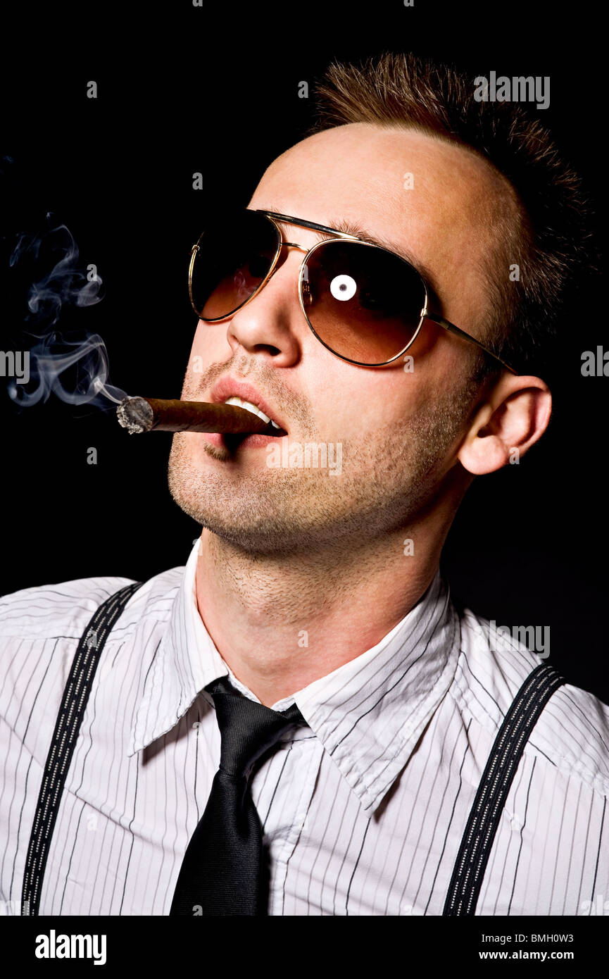 young confident man smoking cigar Stock Photo