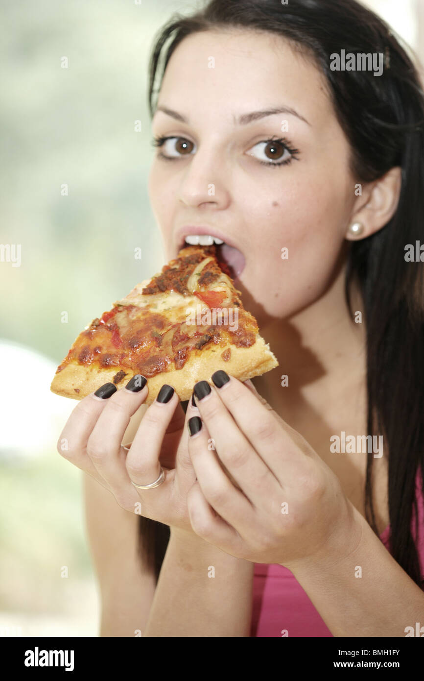 Teenage Girl Eating Pizza Slice. Model Released Stock Photo - Alamy