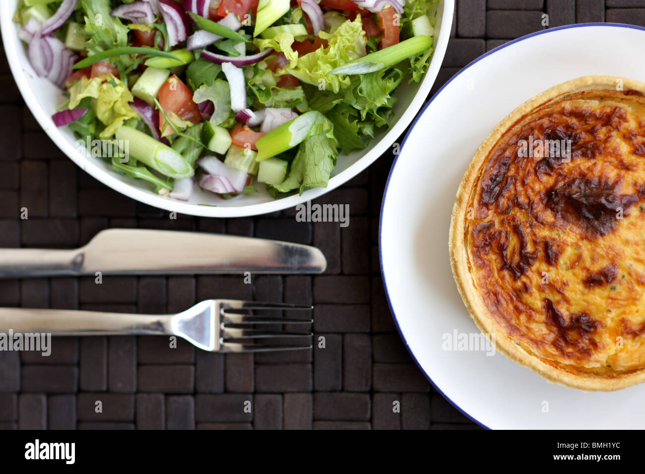 Fresh Healthy Vegetarian Style Cheese and Onion Quiche Tart With A Mixed Garden Summer Salad And No People Stock Photo