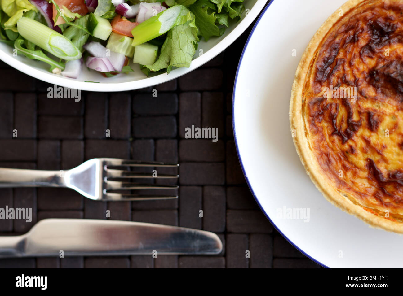 Fresh Healthy Vegetarian Style Cheese and Onion Quiche Tart With A Mixed Garden Summer Salad And No People Stock Photo