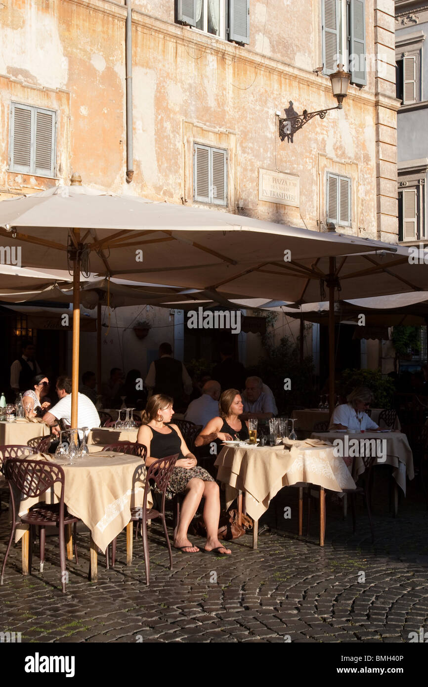 People sitted in a traditional bar in Santa Maria in Trastevere Rome Italy Stock Photo