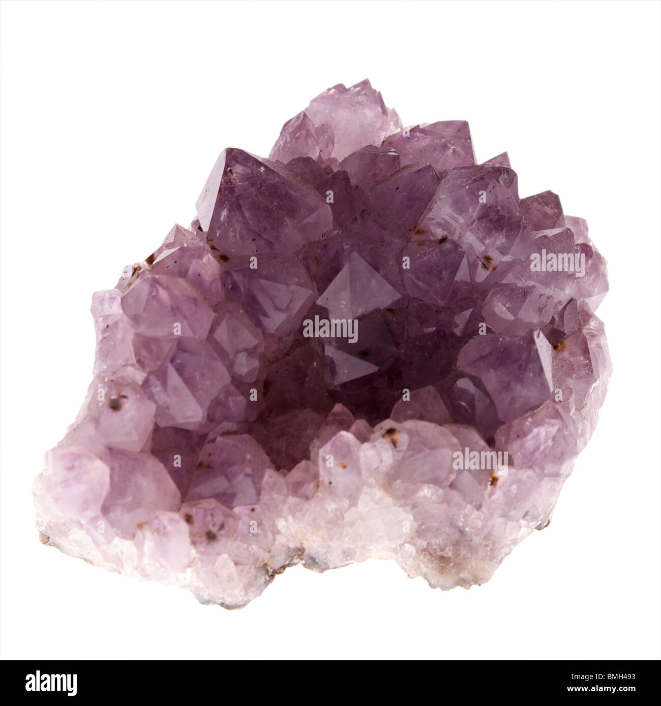 a large chunk of purple amethyst crystal on white, lit from underneath Stock Photo