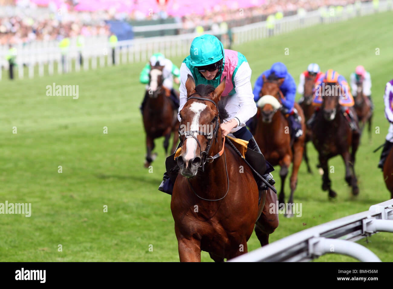 Workforce, ridden by Ryan Moore (green hat) wins the Investec Derby horserace at Epsom, Surrey, UK. Stock Photo