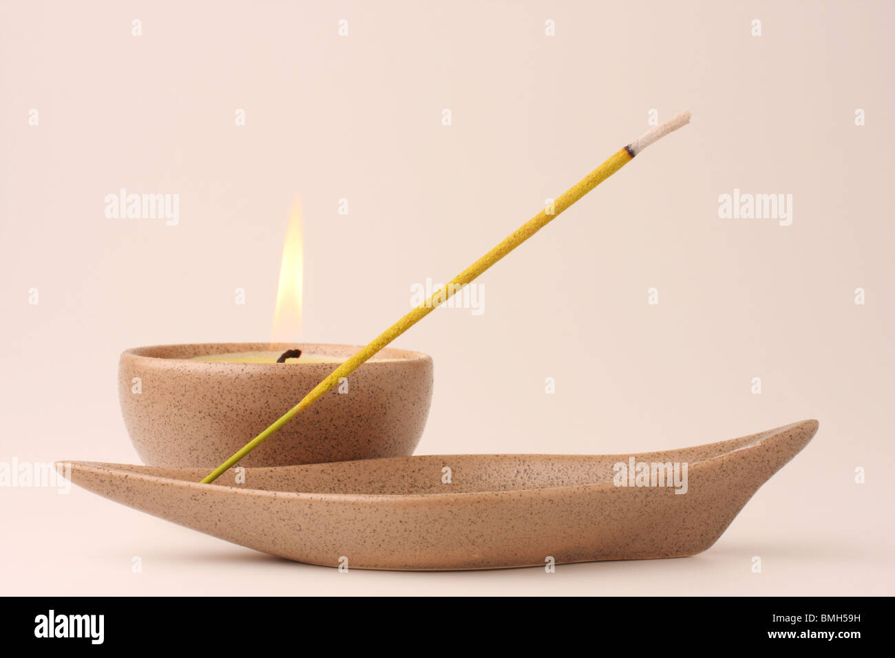 Candle and incense stick in pastel shades Stock Photo Alamy
