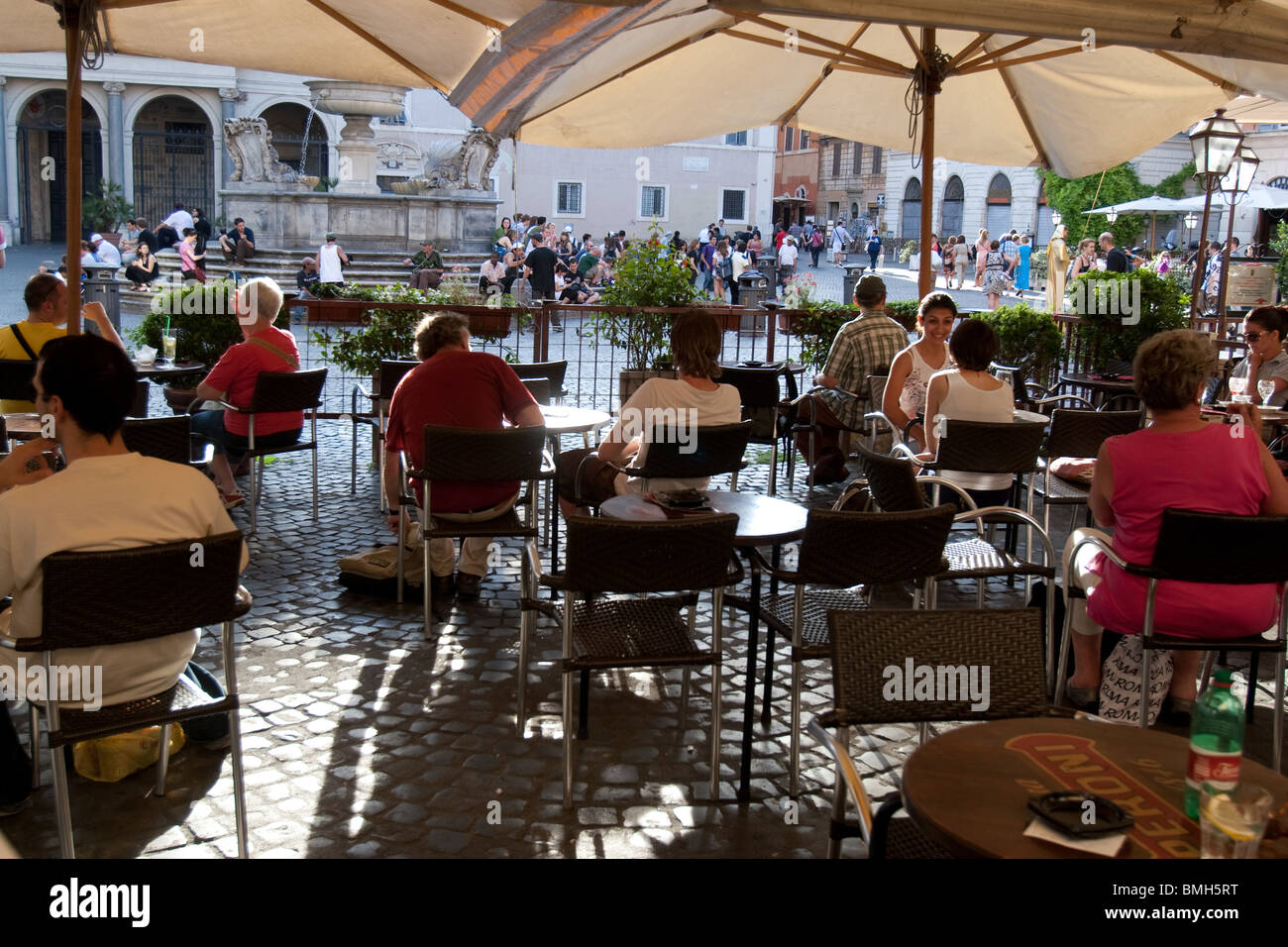 Person sit in a traditional bar in Santa Maria in Trastevere square Rome Italy Stock Photo