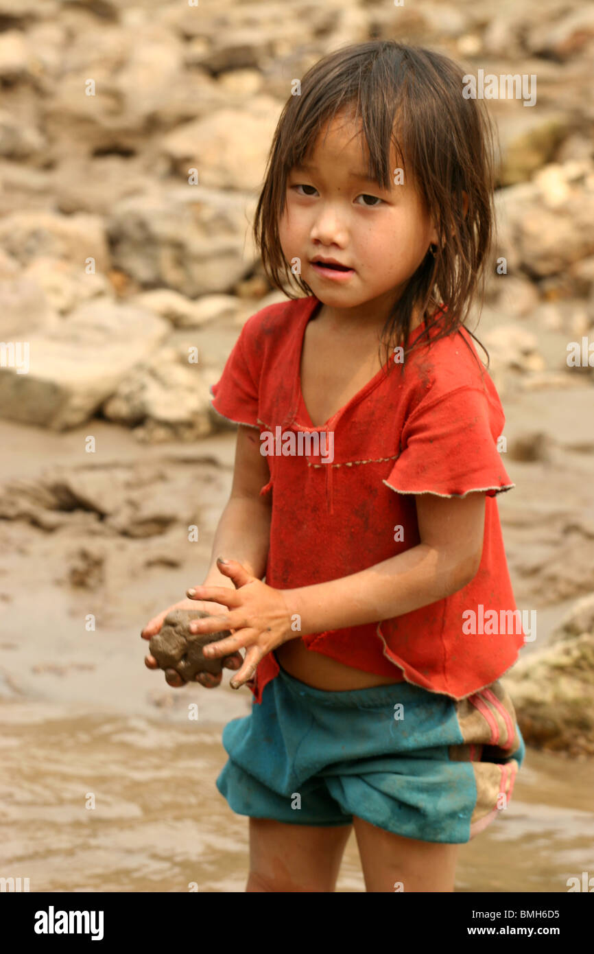 Hmong Child playing on the banks of the Mekong river between Pakbeng and Luang Prabang, Laos. Stock Photo