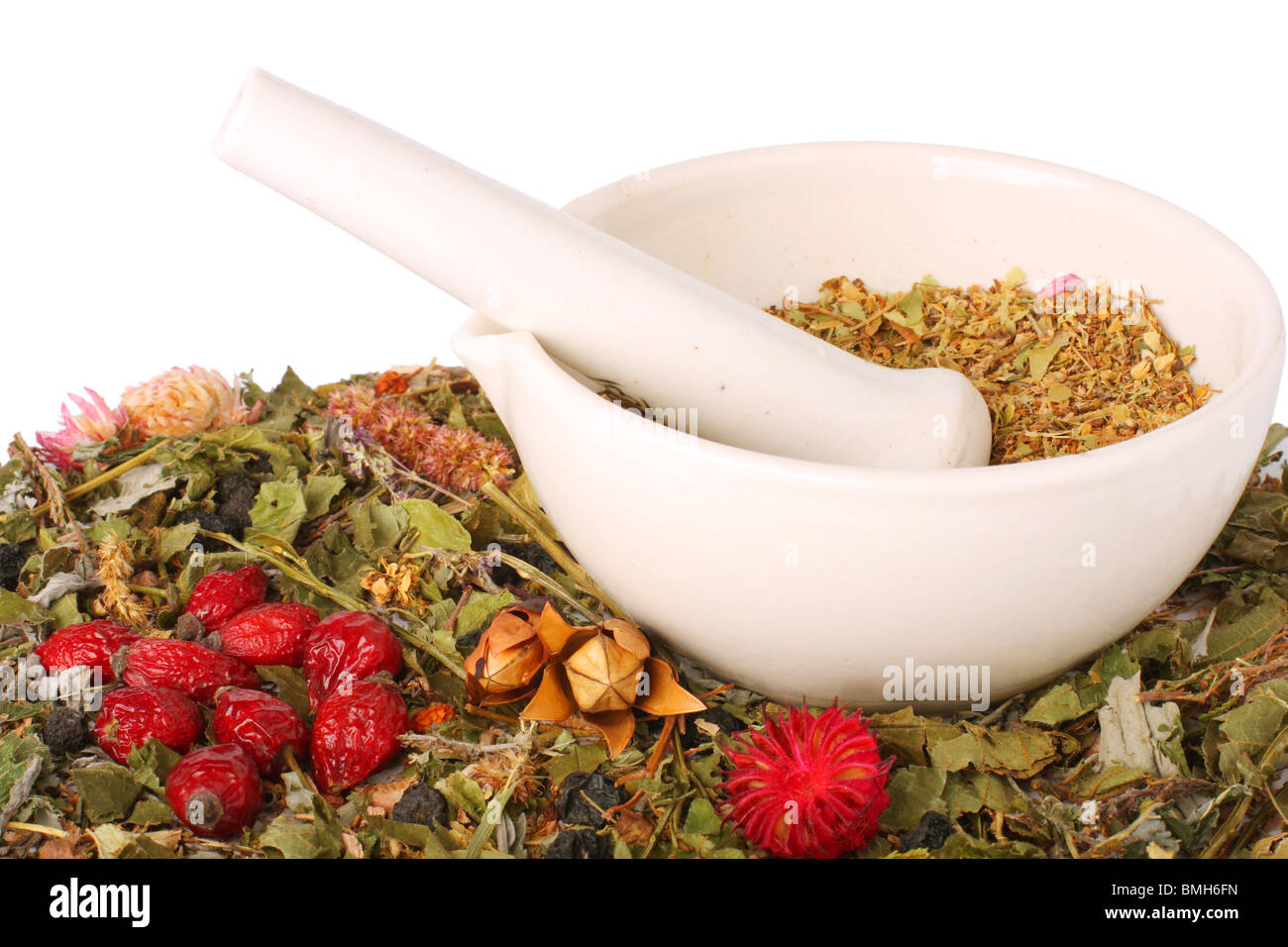 Mortar with dry herbs and hips, isolated on white background Stock Photo