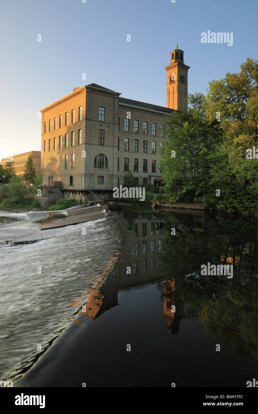 A view of New Mill, at Salts Mill, Saltaire, reflected in the River Aire, Bradford, West Yorkshire Stock Photo