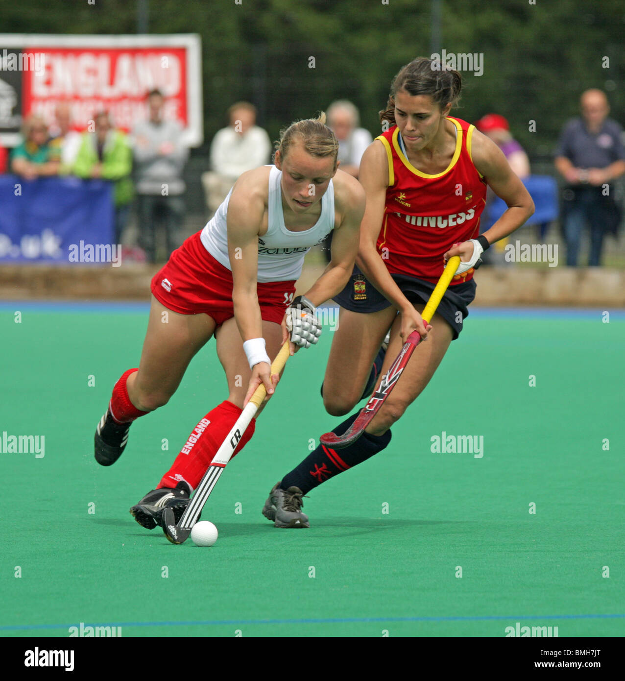 Two players contesting the ball in womens hockey Stock Photo