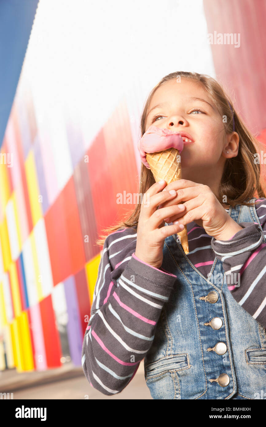 Little girl enjoying ice cream outdoors Stock Photo
