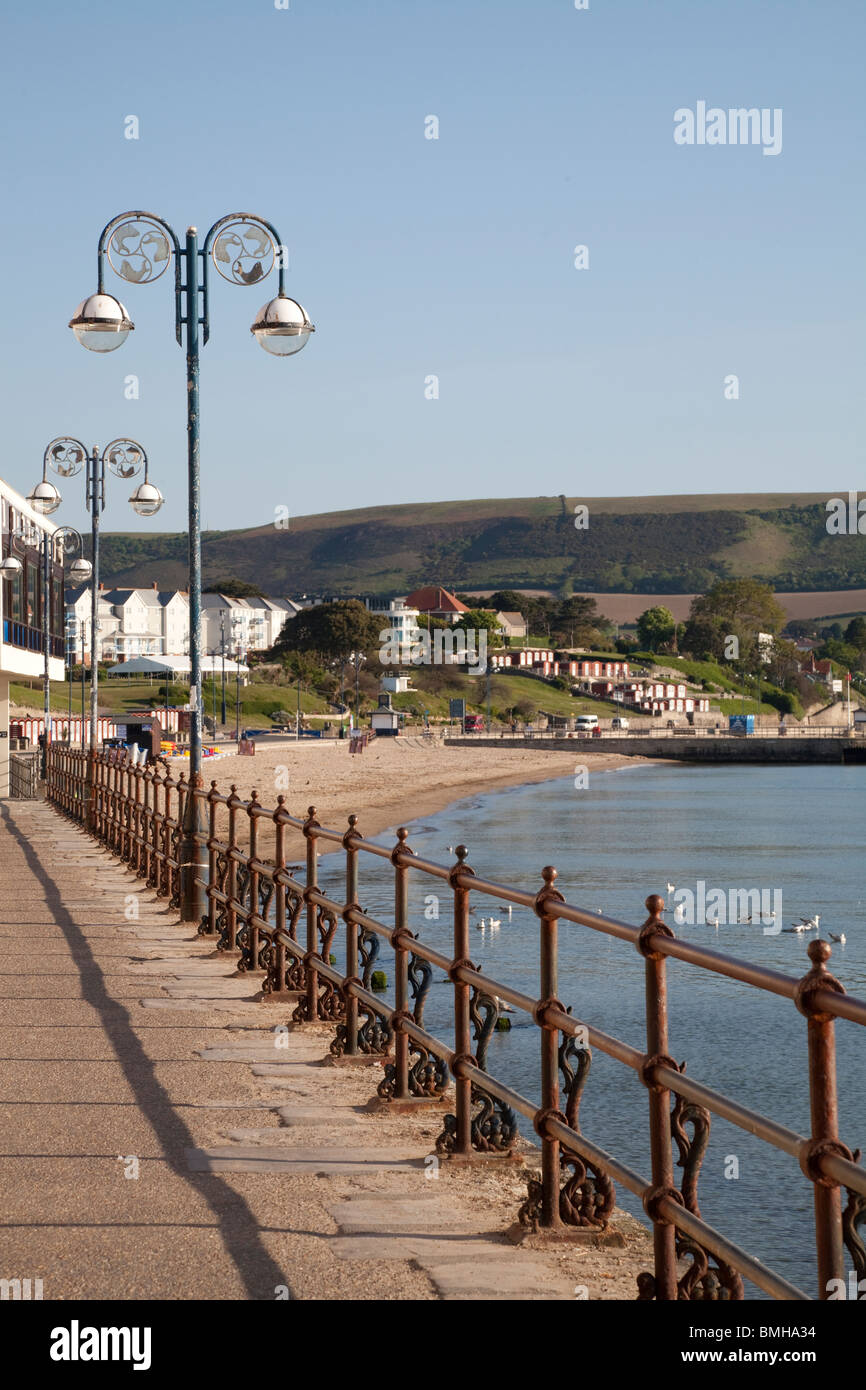 promenade with railings and street lamp on Swanage seafront in early morning sunshine Stock Photo