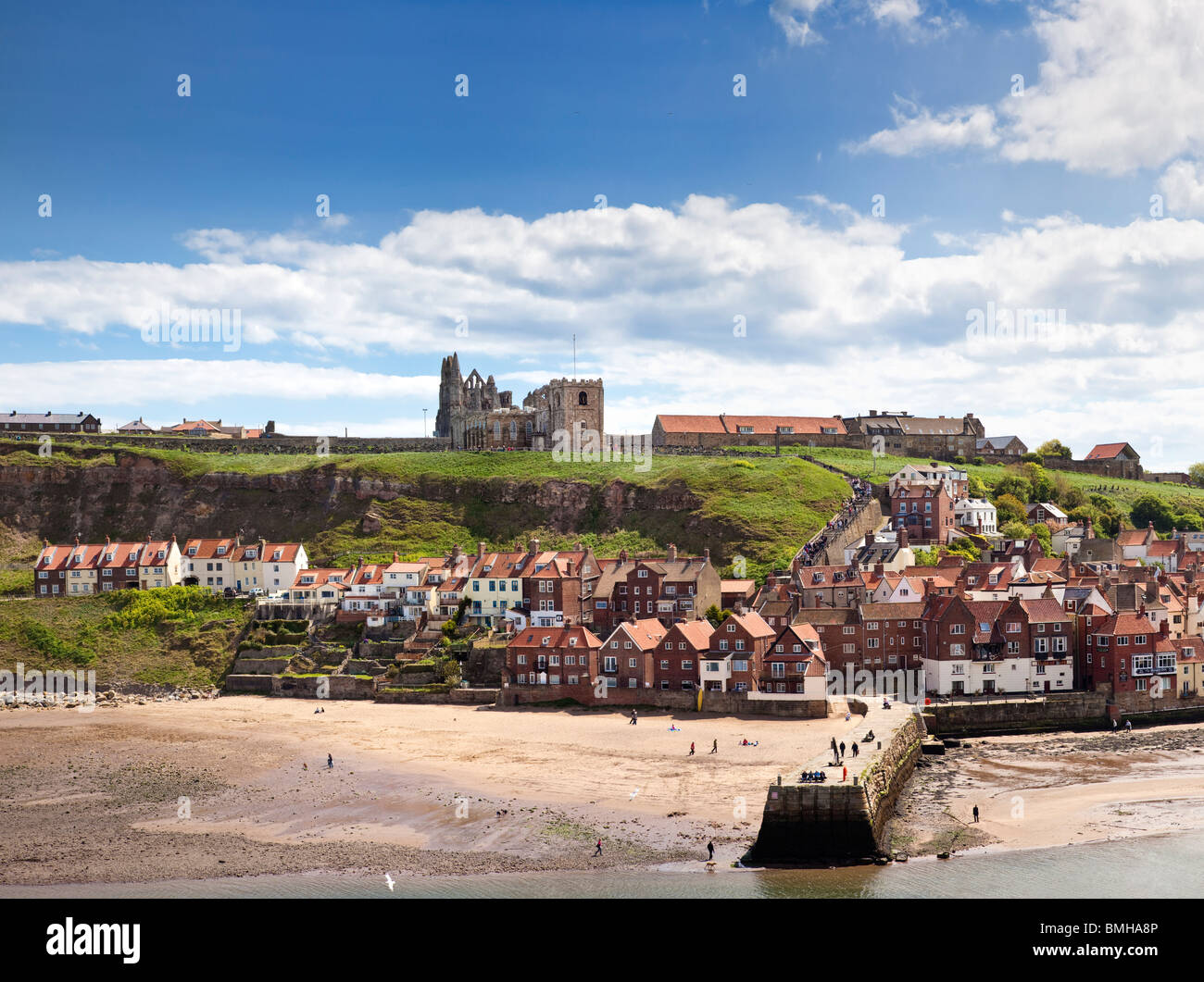 Whitby beach, Abbey and church above the harbour entrance at Whitby, North Yorkshire, England, UK Stock Photo