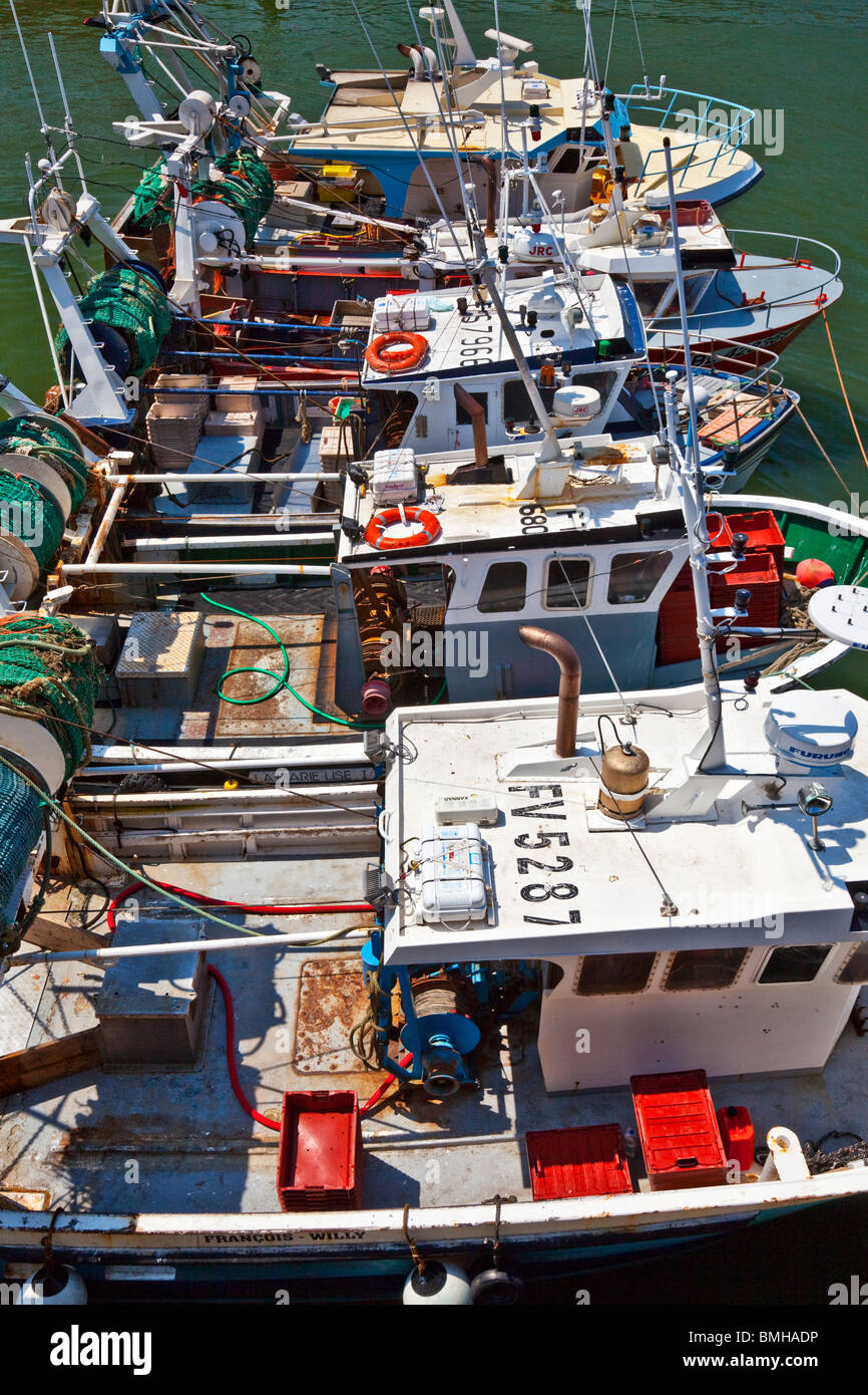 A row of small fishing boats moored in the harbour at Boulogne-sur-Mer in the Pas-de-Calais region of France. Stock Photo