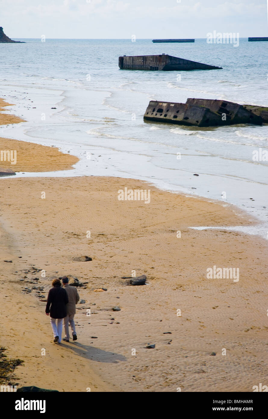 The Beach at Arromanches, Normandy with some of the remains of the Mulberry Harbour used in the 1944 Normandy Landings Stock Photo