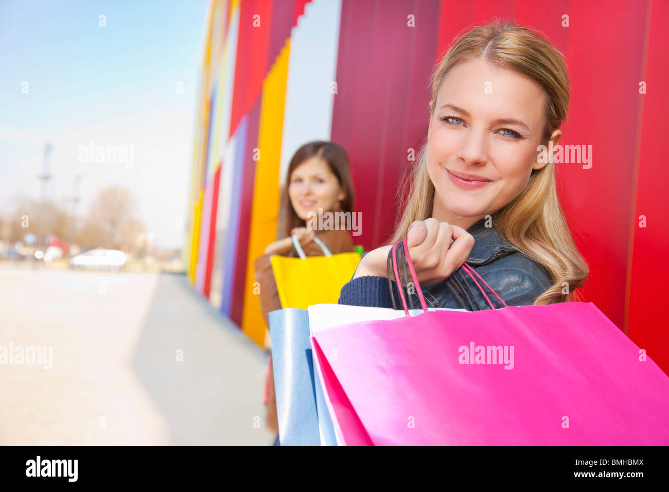 Girls with shopping bags near mall Stock Photo