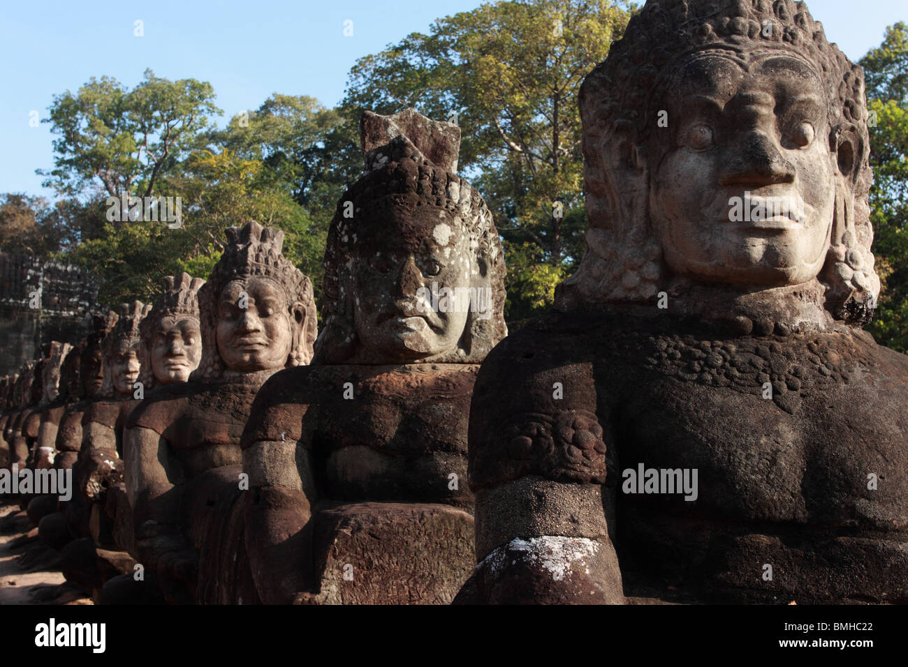 Statues on the bridge at the South Gate, Angkor Thom, Stock Photo