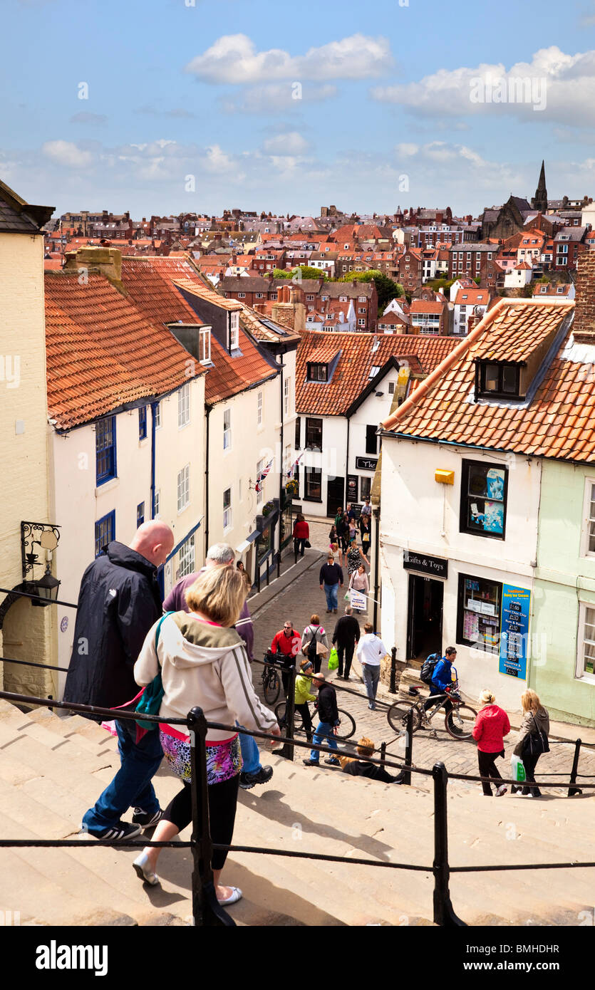 Whitby, UK - Tourists on the famous Whitby Steps with the town of Whitby in the background, North Yorkshire, England, UK Stock Photo