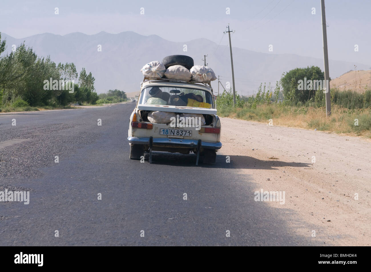 Fully loaded car driving at country - Fully Loaded Car Driving At Country Road Shakrisabz Uzbekistan BMHDK4