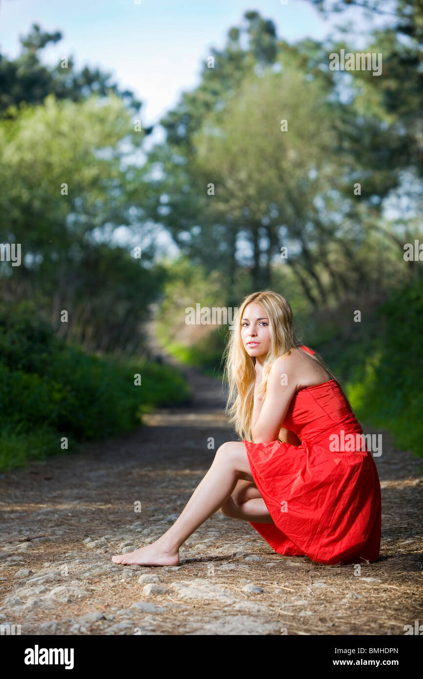 beautiful young girl with a red dress in the nature Stock Photo - Alamy
