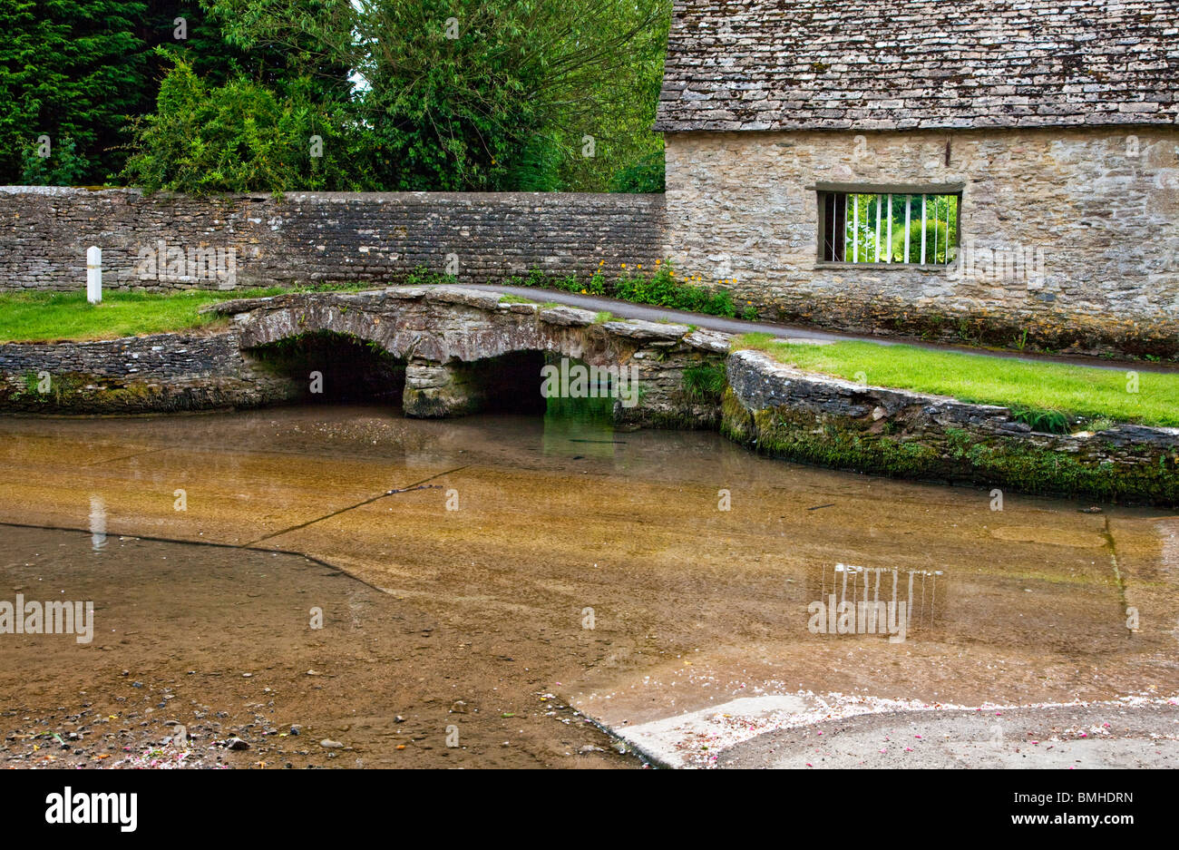 The ford and stone bridge in the pretty Cotswold village of Shilton, Oxfordshire, England, UK Stock Photo
