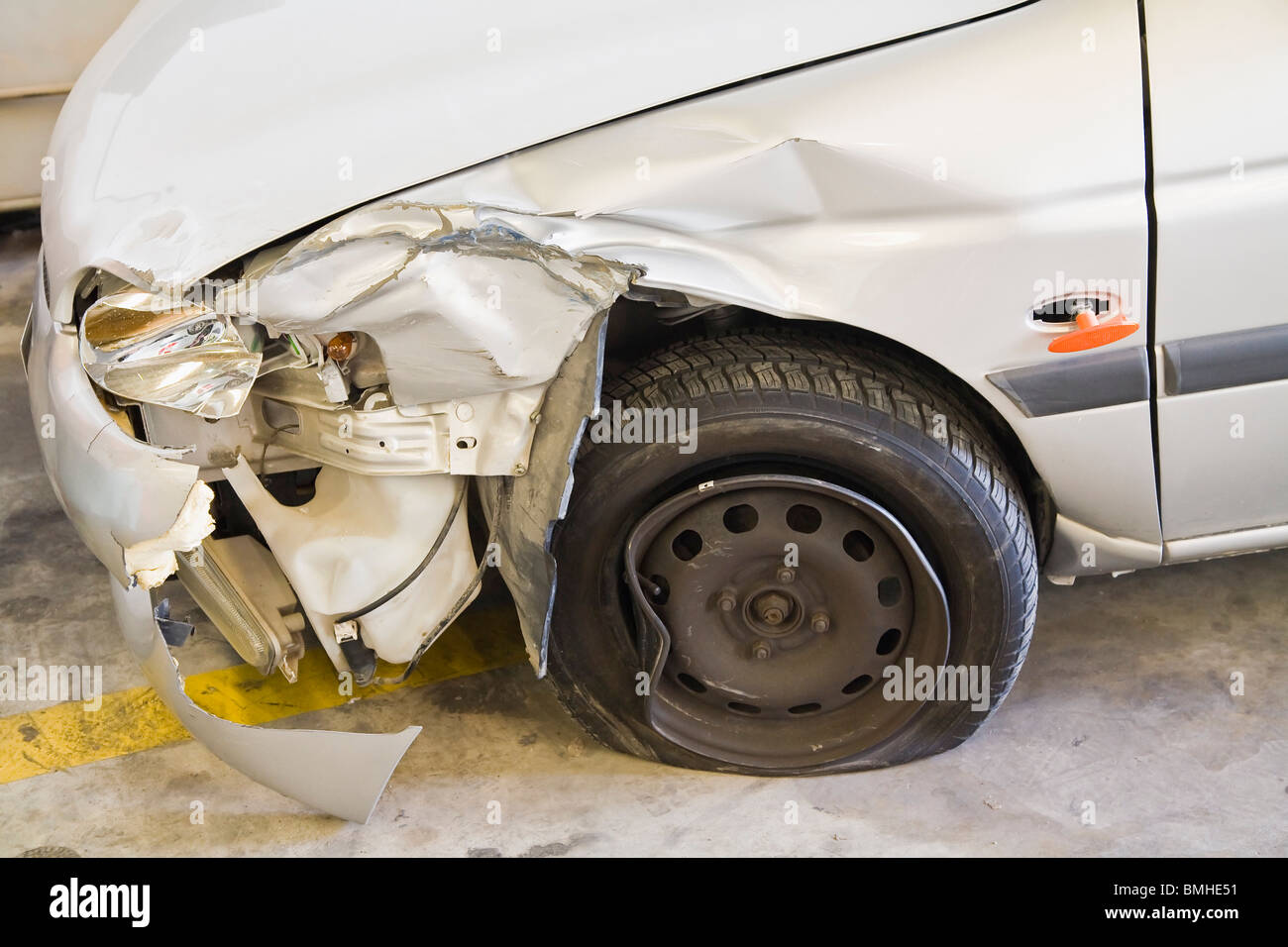 Smashed Car; Car With Smashed Front Fender And A Flat Tire Stock Photo