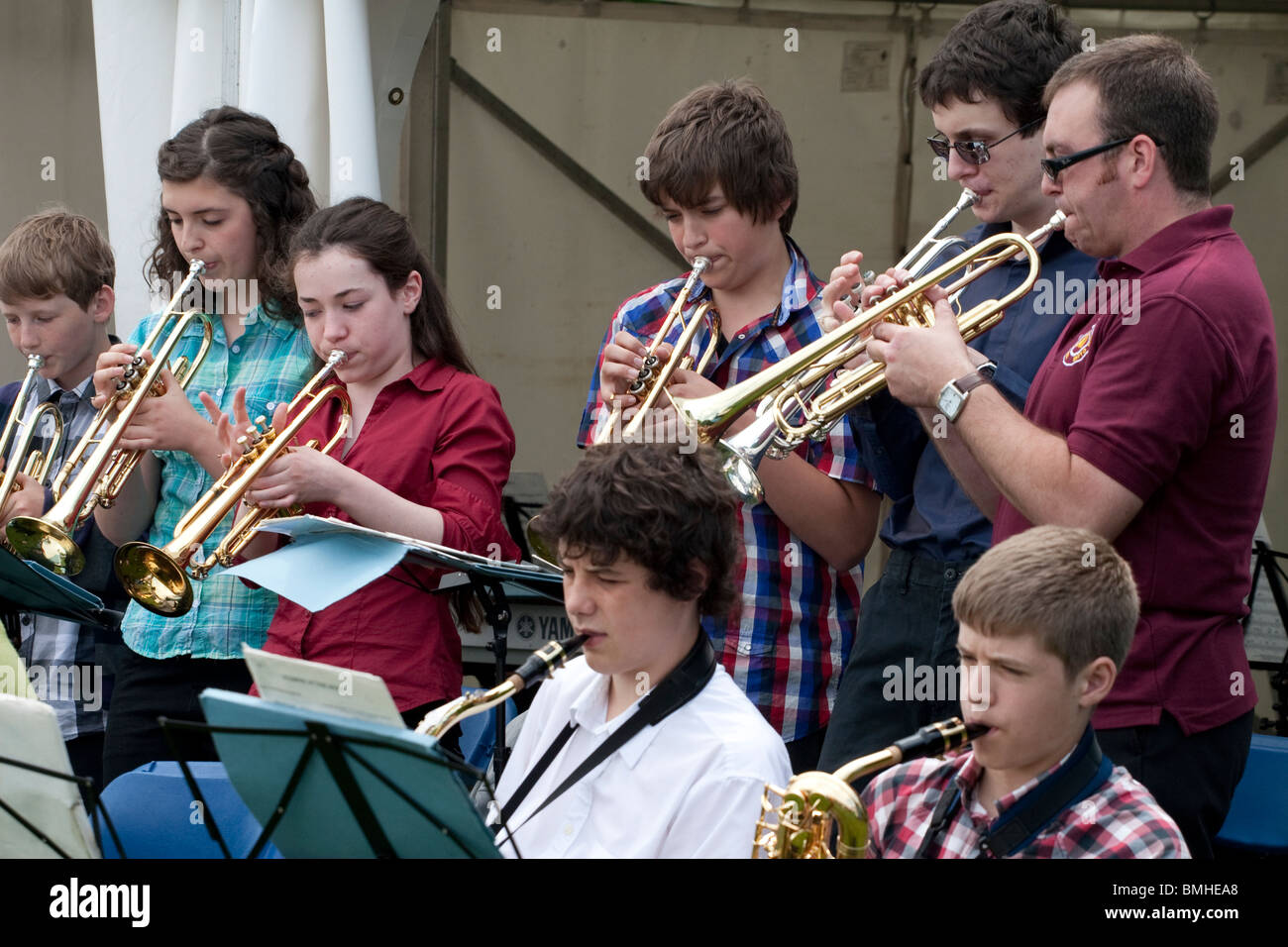 A mixture of school children and teachers performing at a fair Stock Photo