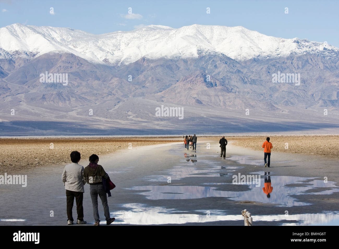Tourists walking on Badwater Basin. Lowest point in the United States. Death Valley National Park, California. Stock Photo