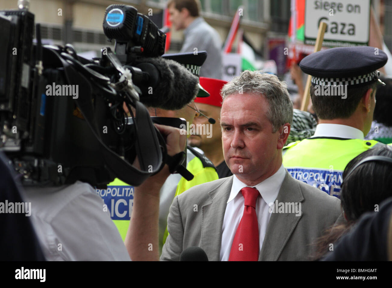 A TV News Reporter broadcasting at the 'Freedom for Palestine' demonstration outside the Israeli Embassy London, England, U.K. Stock Photo