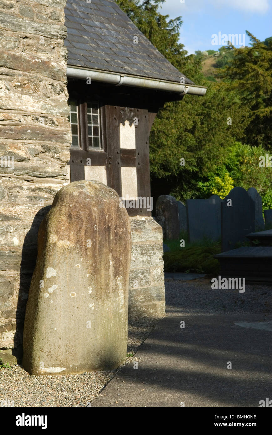 Maentwrog, Standing Stone outside porch of Parish Church. Gwynedd North Wales UK HOMER SYKES Stock Photo