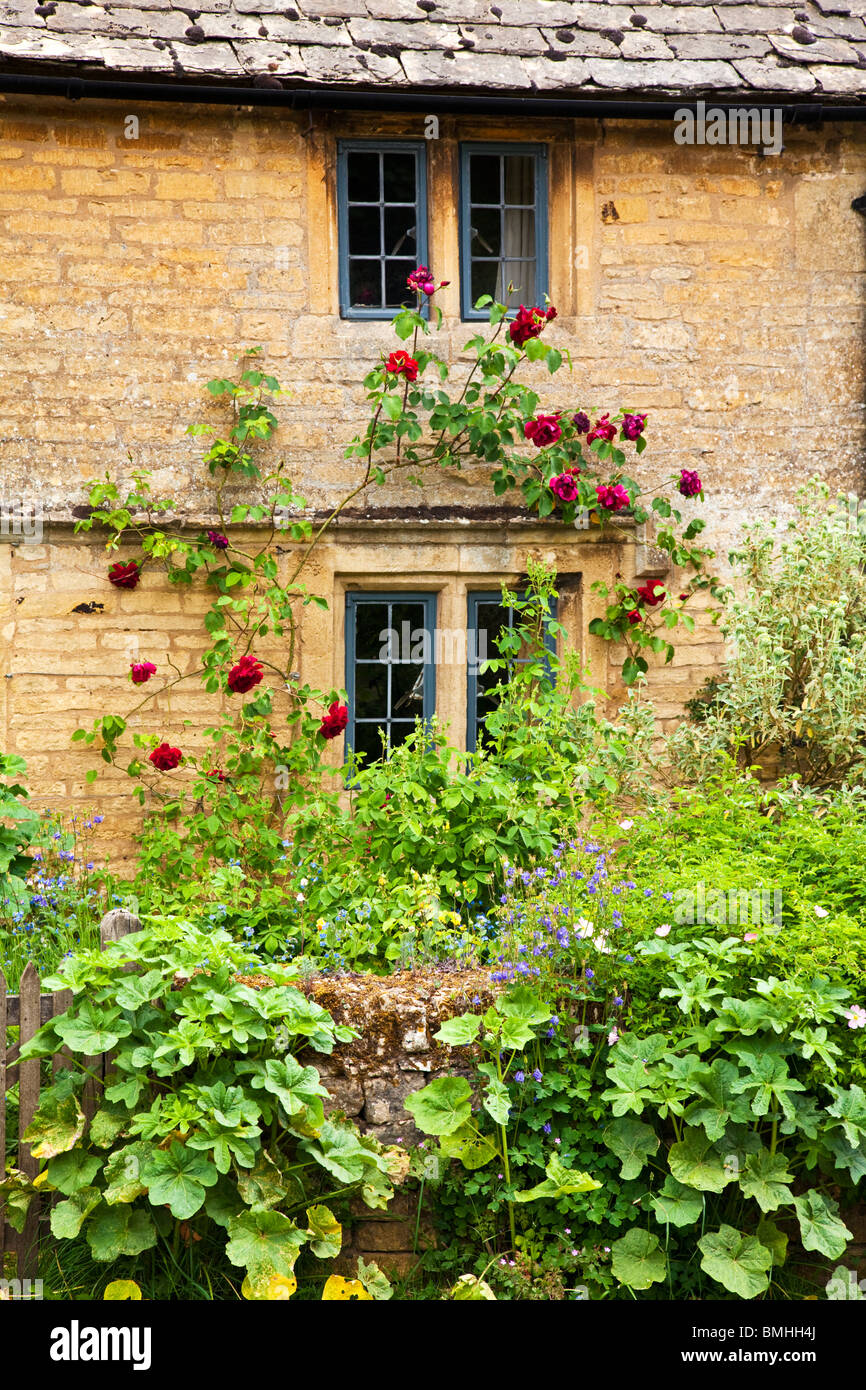 A charming Cotswold cottage mullioned window with leaded lights and red