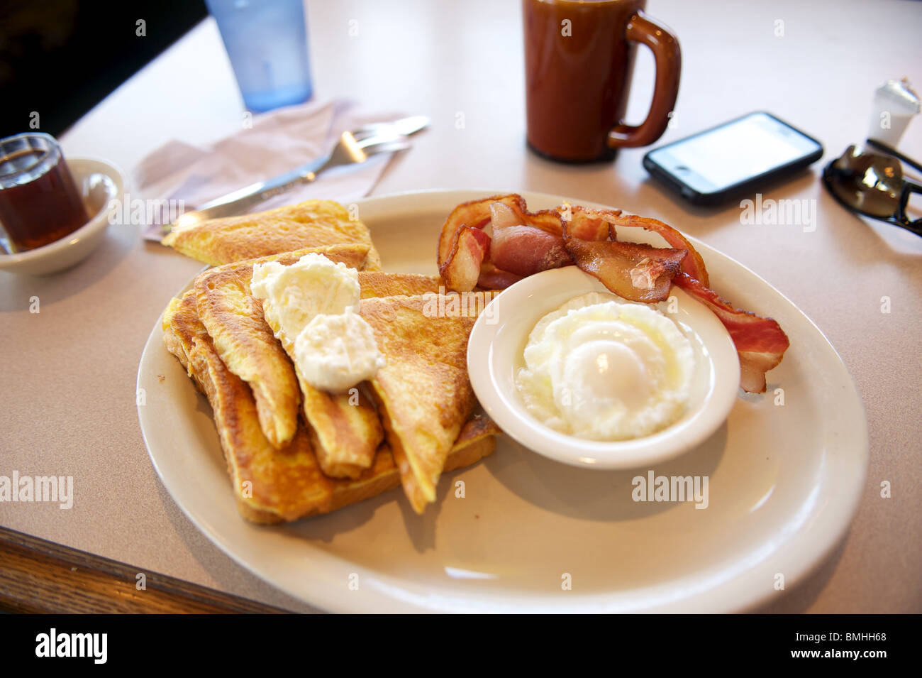 Highway truck stop breakfast. French Toast with bacon and eggs. Off of