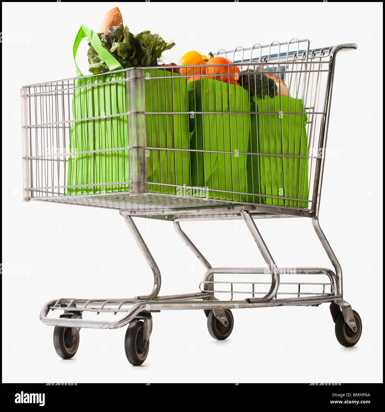 Grocery cart full of bagged produce Stock Photo