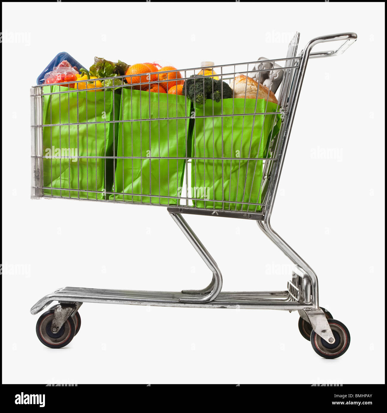 Grocery cart full of bags of groceries Stock Photo