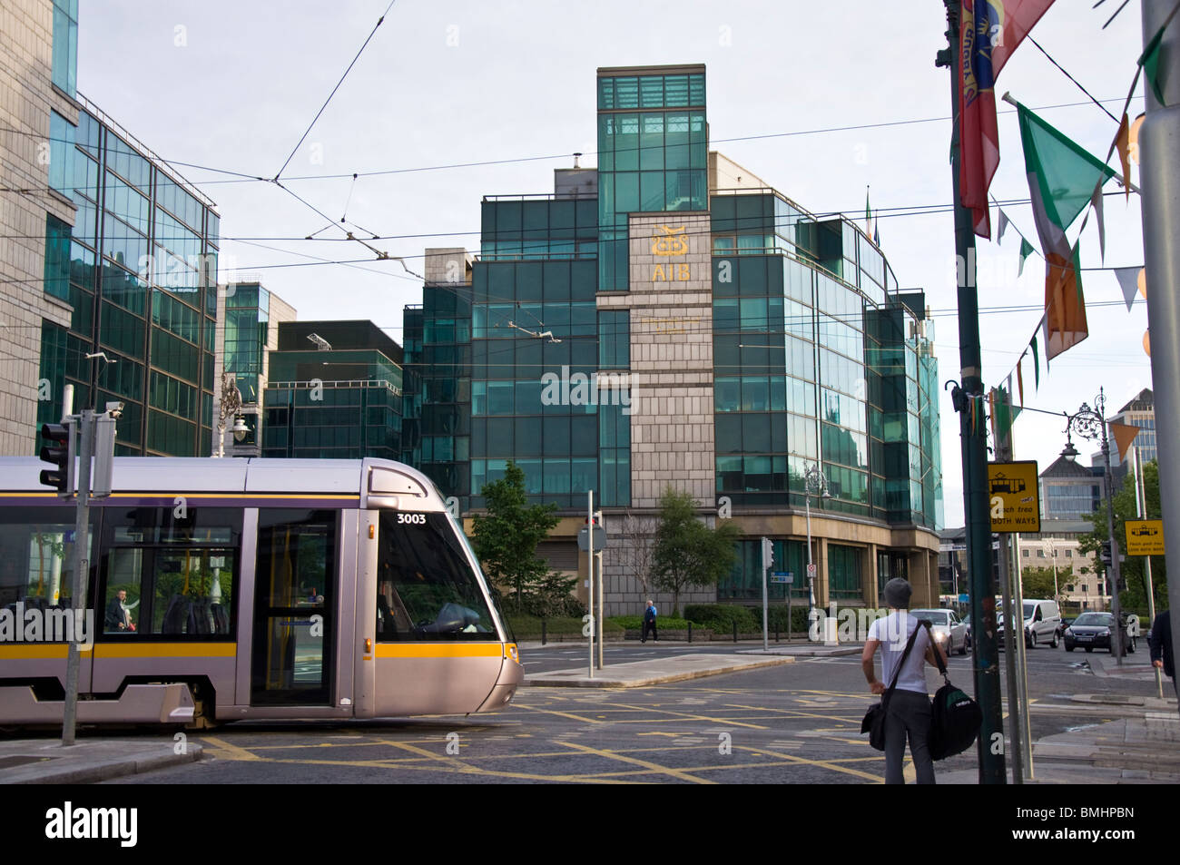 A LUAS tram passes in front of AIB headquarters, Allied Irish Bank, in the city Stock Photo