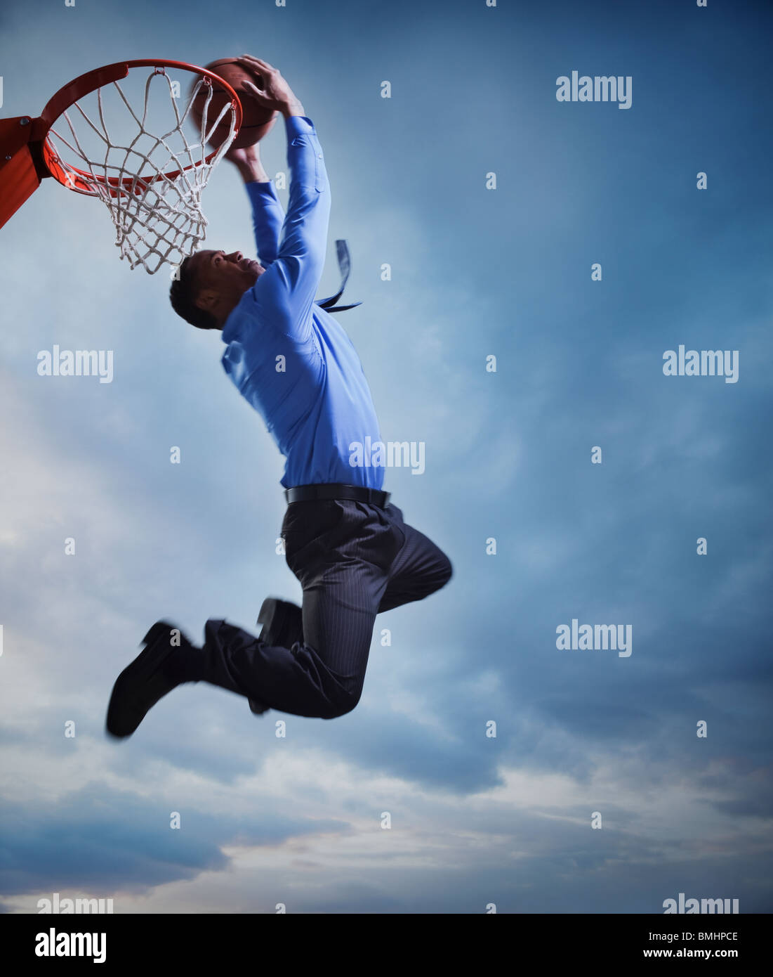 Businessman playing basketball Stock Photo