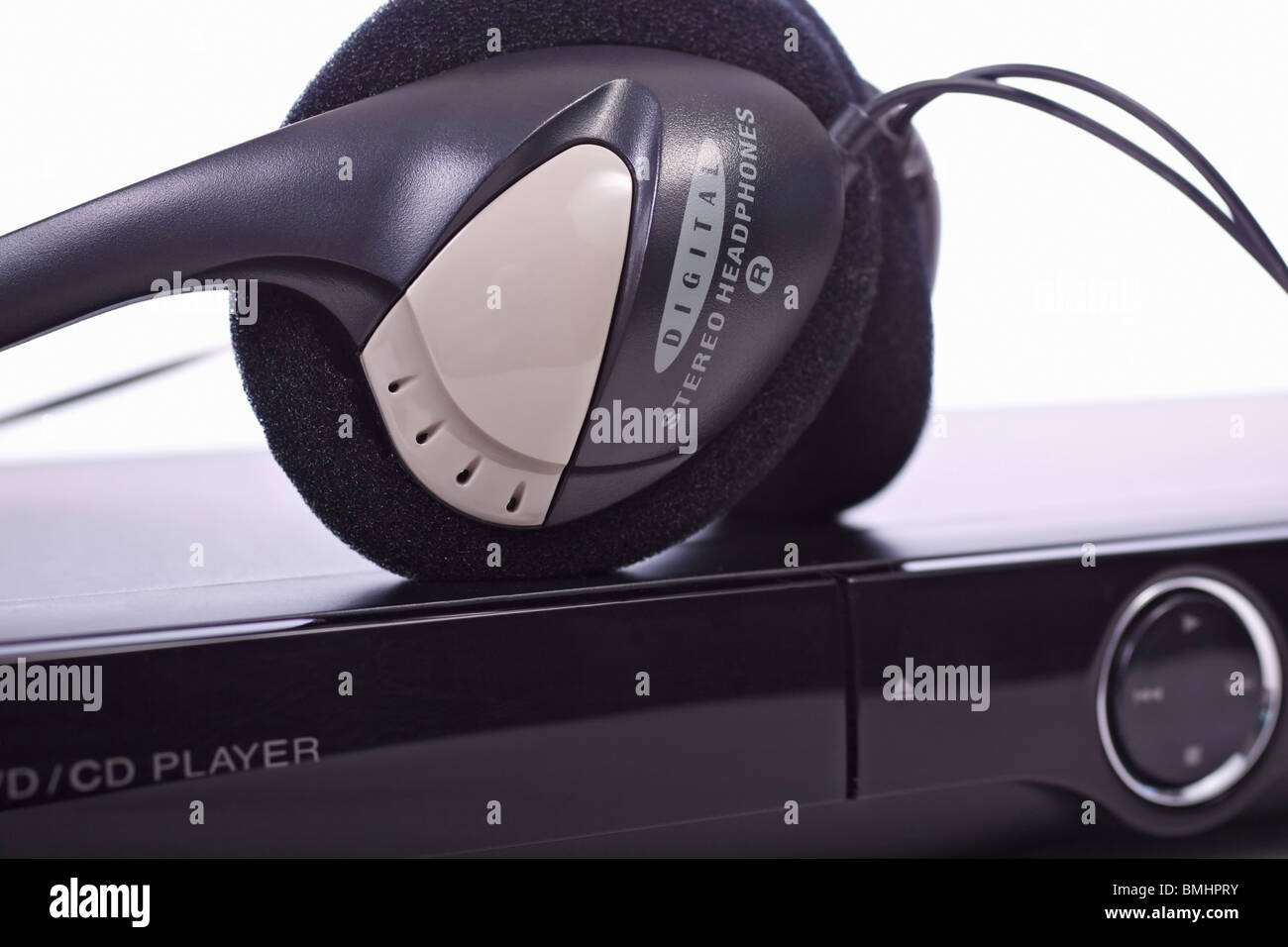 Close-up of stereo headphones and DVD/CD player. Foreground focus. Stock Photo