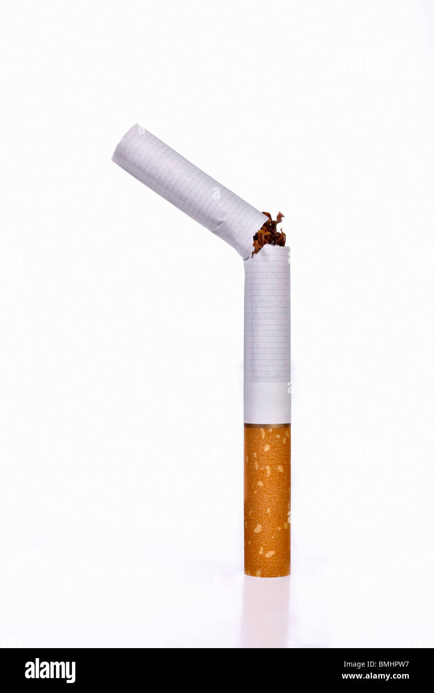 Upright broken cigarette. Isolated. Copy space. Stock Photo