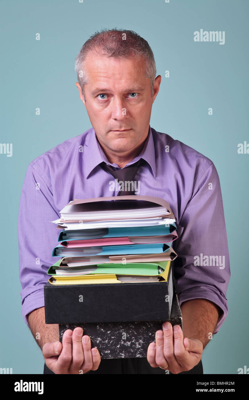Man holding a stack of paper work Stock Photo Alamy