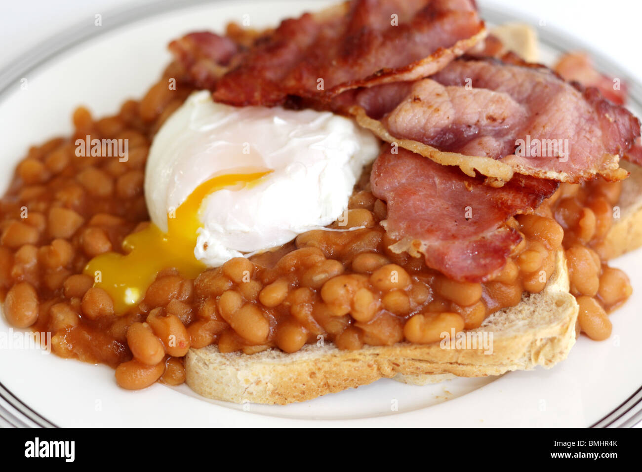 Poached Egg with Bacon and Baked Beans on Toast Stock Photo