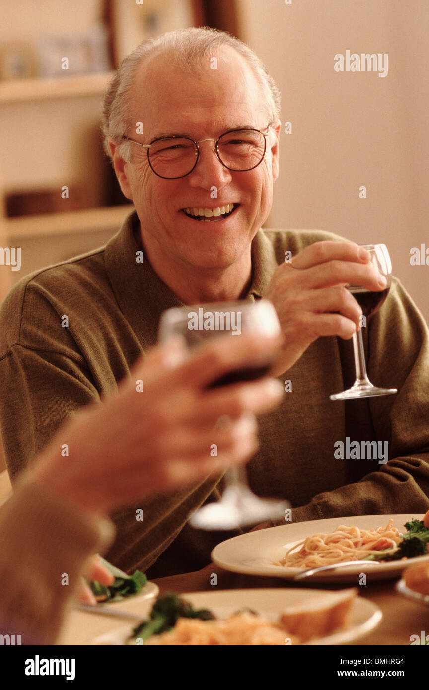 Toasting with wine at the dinner table Stock Photo Alamy
