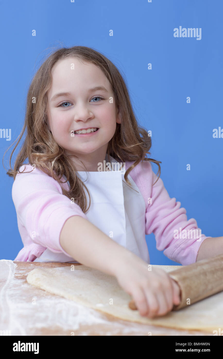 Young girl rolling out bread dough Stock Photo Alamy