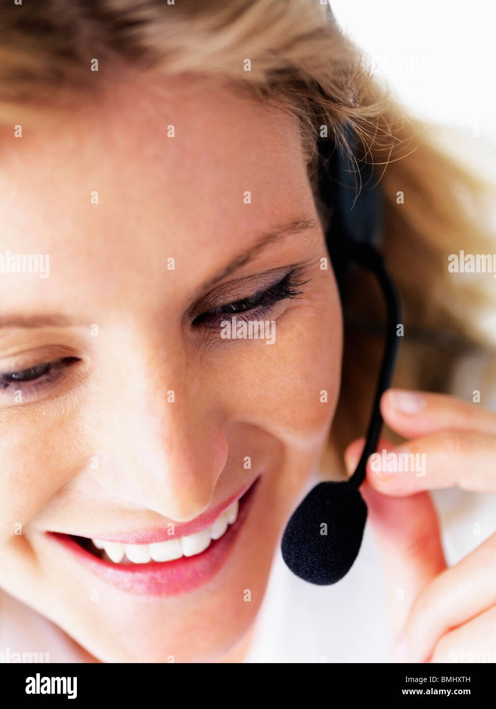Receptionist wearing headset Stock Photo Alamy