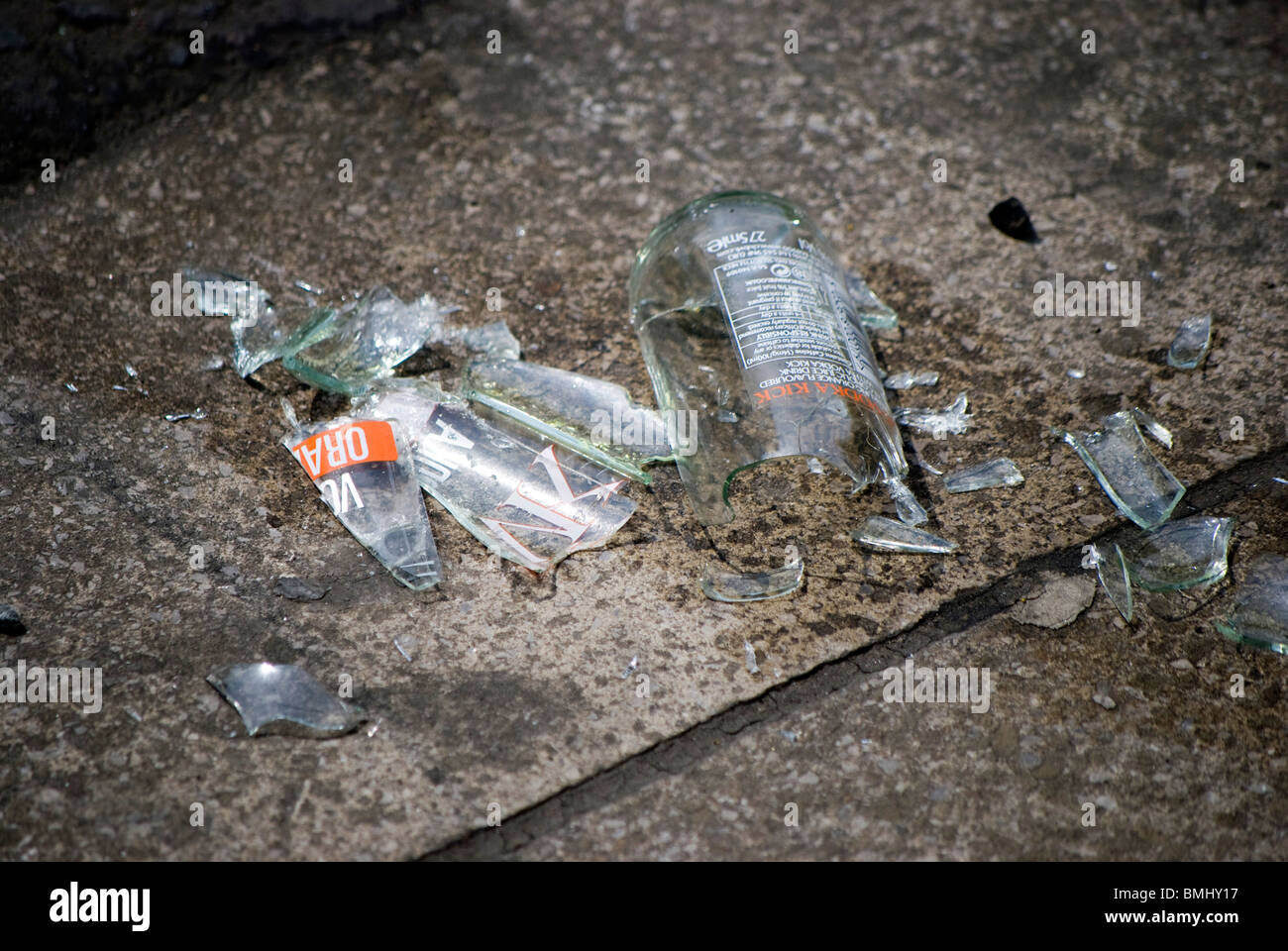 Broken glass alcopop bottle lying on a pavement in the centre of Edinburgh, Scotland. Stock Photo